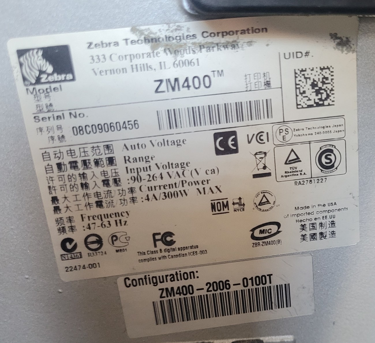 The compliance plate on a Zebra ZM400 printer, reading Zebra Technologies
                  Corporation, Vernon Hills Illinois, model ZM400, serial number 08C09060456, and
                  Made in the USA of imported components.